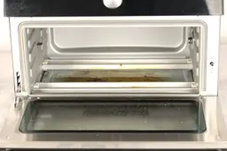 Grease on the slide-out crumb tray inside the cooking chamber of the Instant Omni Plus 18L 10-in-1 Air Fryer Toaster Oven.