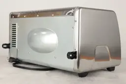 The back and left sides of the Black+Decker CTO6335S Toaster Oven. The back has air ventilation holes and two black buffers.