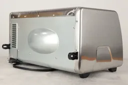The back and left sides of the Black+Decker CTO6335S Toaster Oven. The back has air ventilation holes and two black buffers.