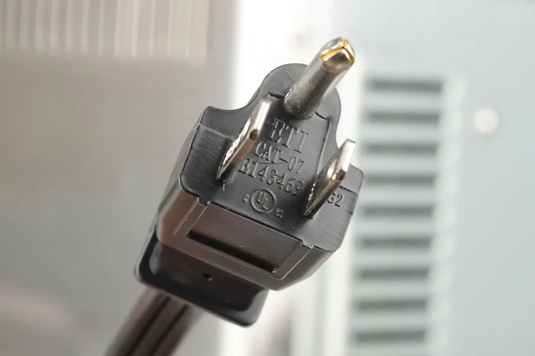 A three-pronged plug power cord. In the background is the stainless steel BLACK+DECKER CTO6335S Convection Toaster Oven.