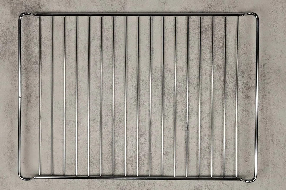 A stainless steel baking rack of the stainless steel BLACK+DECKER CTO6335S Convection Toaster Oven on a grey background.