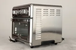 The front and the right sides of a closed Cuisinart TOA-60 Convection Toaster Oven Air Fryer on a white background. The control panel is in the front. The right side has air ventilation holes.