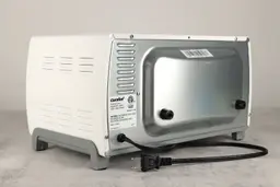 The back and left sides of the Comfee CFO-BB101 Compact Toaster Oven have holes. The back has a power cord and two buffers.