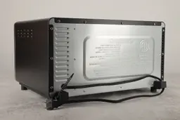The back and left sides of the Cuisinart TOB-40N have air ventilation holes. The back has a power cord and two buffers.
