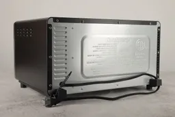 The back and left sides of the Cuisinart TOB-40N have air ventilation holes. The back has a power cord and two buffers.