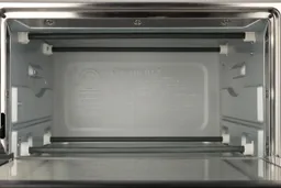 The Cuisinart TOB-40N Toaster Oven’s cooking chamber has 4 nichrome heating elements, 2 guide rails, and a safety hook.