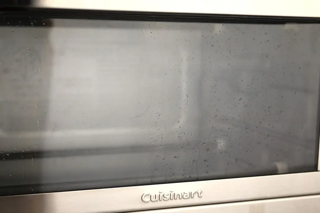 Grease on the glass door of a closed stainless steel Cuisinart TOB-40N Custom Classic Toaster Oven Broiler.