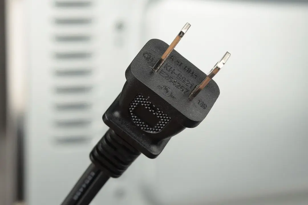 A two-pronged plug power cord. In the background is the Hamilton Beach 31401 4-Slice Capacity Countertop Toaster Oven.