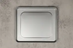 A silver baking pan of the stainless steel Hamilton Beach 31401 4-Slice Countertop Toaster Oven on a grey background.