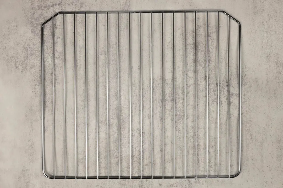 A stainless steel baking rack of the Oster TSSTTVMNDG-SHP-2 6-Slice Digital Convection Toaster Oven on a grey background.