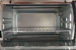 Grease on the stainless steel Oster TSSTTVMNDG-SHP-2 6-Slice Large Digital Convection Toaster Oven’s cooking chamber wall.