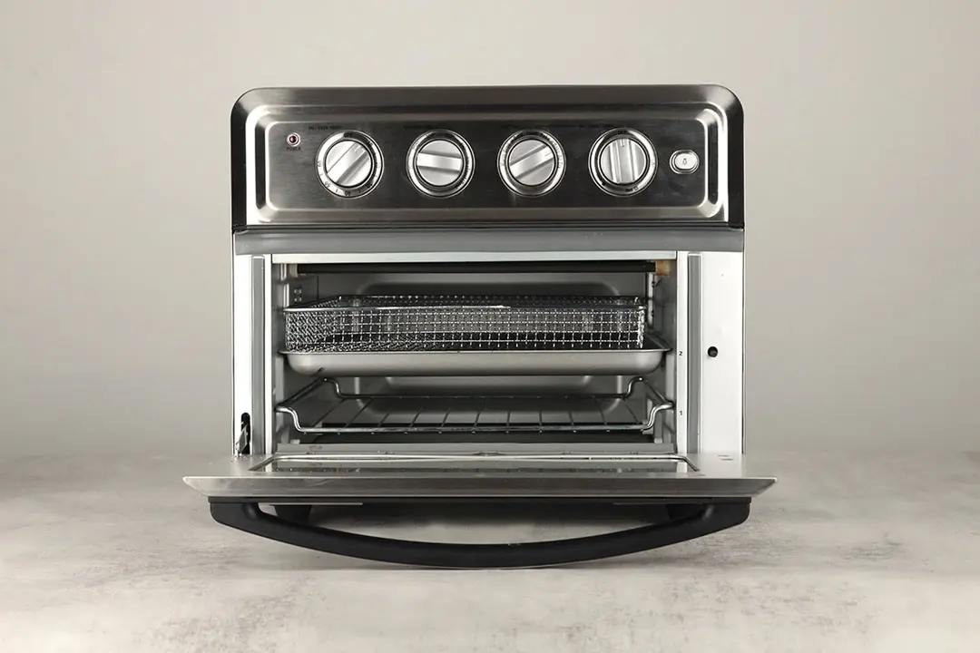 The front of an opened Cuisinart TOA-60 Convection Toaster Oven Air Fryer on a white background. From the bottom up are one baking rack, one baking pan, and an air fryer basket.