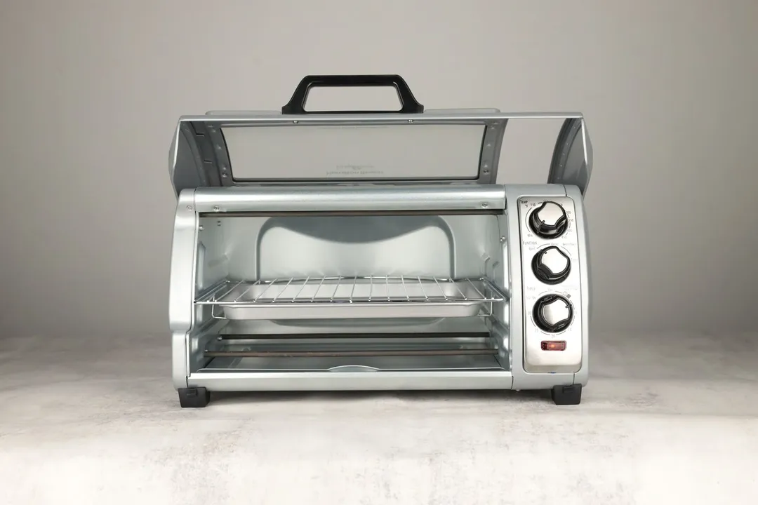 The front of an opened Hamilton Beach 31127D 6-Slice Toaster Oven with a removable crumb tray, baking pan, and oven rack.