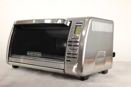 The front of a closed Black+Decker CTO6335S Convection Toaster Oven has a control panel and the right has ventilation holes.