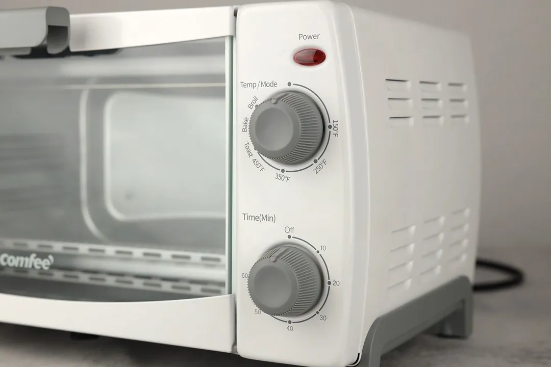 The mode dial of the white Comfee CFO-BB101 Compact Toaster Oven has 3 cooking functions including Toast, Bake, and Broil.