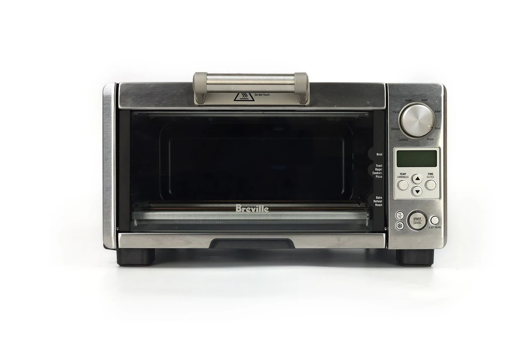 The front of a closed stainless steel Breville BOV450XL Mini Smart Toaster Oven on a white background.