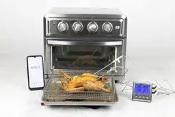A tray of whole toaster oven roasted chicken. The thermometer has two probes inside the chicken and displays 205°F and 207°F.