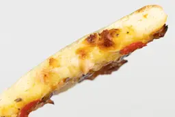 The cross surface of a slice of toast oven baked 9-inch thick-crust meat pizza with cheese, onions, and green bell peppers.