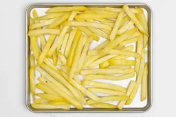 Pieces of baked french fries using the Hamilton Beach 31401 Toaster Oven on a silver baking pan on a white background.