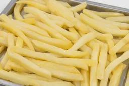 A close-up of pieces of baked french fries using the Black+Decker TO1760SS on a silver baking pan on a white background.
