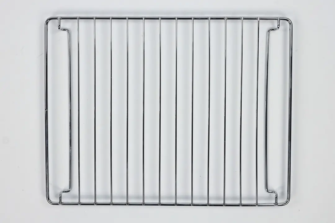 A stainless steel baking rack of the Black+Decker TO1760SS 4-Slice Natural Convection Toaster Oven on a white background.