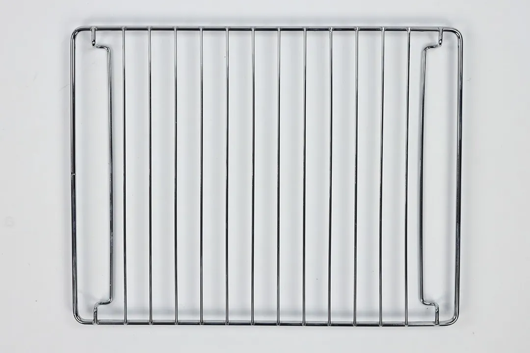 A stainless steel baking rack of the Black+Decker TO1760SS 4-Slice Natural Convection Toaster Oven on a white background.
