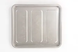 The cleaned silver baking pan of the stainless steel Black+Decker TO1760SS 4-Slice Natural Convection Toaster Oven.