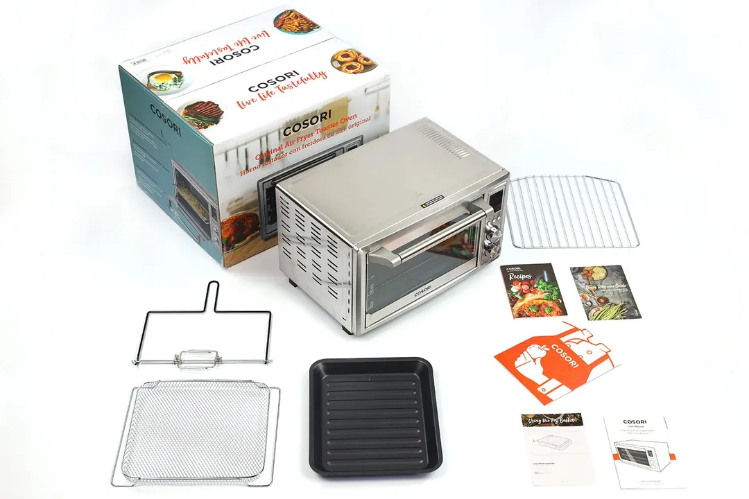 A box, the Cosori CO130-AO, rotisserie kit and lifter, air fryer basket, baking pan, oven rack, and 6 pieces of documents.