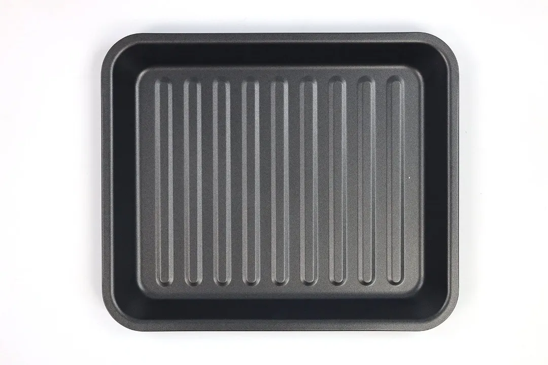 A grooved grey baking pan of the Cosori CO130-AO 30L 12-In-1 Dehydrator Rotisserie Toaster Oven on a white background.