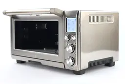 Breville Smart Oven Pro Toaster Oven ExteriorThe front of a closed Breville BOV845BSSUSC Convection Toaster Oven has a control panel and the right has ventilation holes.