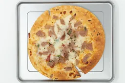  Hamilton Beach easy reach 4 slices toaster PizzaA toaster oven baked 9-inch thick-crust meat pizza with cheese, onions, and green bell peppers on top inside a baking pan.