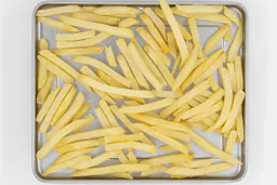 Pieces of baked french fries using the Hamilton Beach 31344DA Toaster Oven on a silver baking pan on a white background.