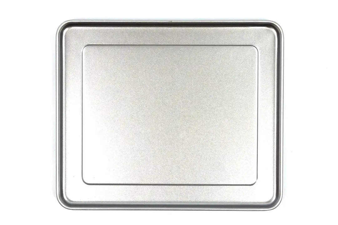 A silver baking pan of the Hamilton Beach 31344DA 4-Slice Easy Reach With Roll Top Door Toaster Oven on a white background.