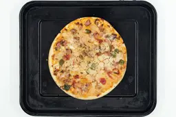 Ninja Foodi XL Pro Air Toaster Oven PizzaA toaster oven baked 9-inch thick-crust meat pizza with cheese, onions, and green bell peppers on top inside a baking pan.