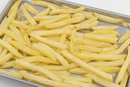 A close-up of pieces of baked french fries using the Mueller MT-175 Toaster Oven on a baking pan on a white background.