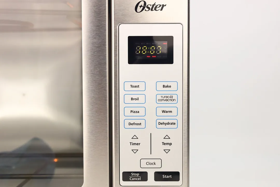 The control panel of the Oster TSSTTVFDDG Toaster Oven has an LCD and 15 flat buttons for Toast, Bake, Broil, Turbo Convection, Pizza, Warm, Defrost, Dehydrate, Timer, Temp, Clock, Stop/Cancel, and Start.