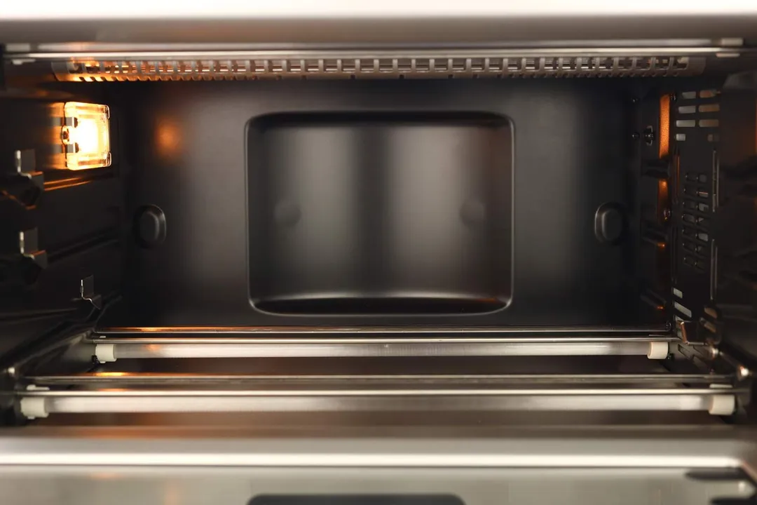 The interior of the Breville BOV845BSSUSC Toaster Oven is black. It has four quartz heating elements with guards, three rack levels with safety hooks, and a shining light.The interior of the Breville BOV845BSSUSC Toaster Oven is black. It has four quartz heating elements with guards, three rack levels with safety hooks, and a shining light.