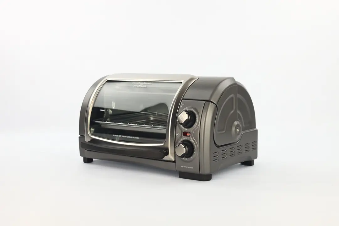 The front of a closed Hamilton Beach 31344DA 4-Slice Easy Reach Toaster Oven has a control panel and the right has holes.