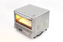 The top, front, and right sides of the Panasonic NB-G110P FlashXpress Compact Toaster Oven on a white background.