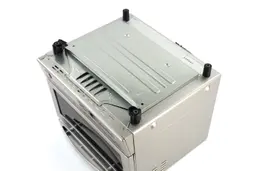 On a white background, the bottom of the Panasonic NB-G110P FlashXpress Toaster Oven has a slide-out crumb tray and 4 stands.