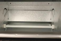 The rack-pulling mechanism and bottom quartz ceramic heating element inside the Panasonic NB-G110P Oven’s cooking chamber.
