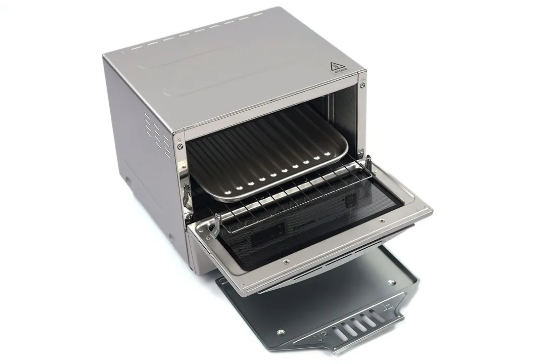 The front of an opened Panasonic NB-G110P FlashXpress Toaster Oven with a slide-out crumb tray, oven rack, and baking pan.
