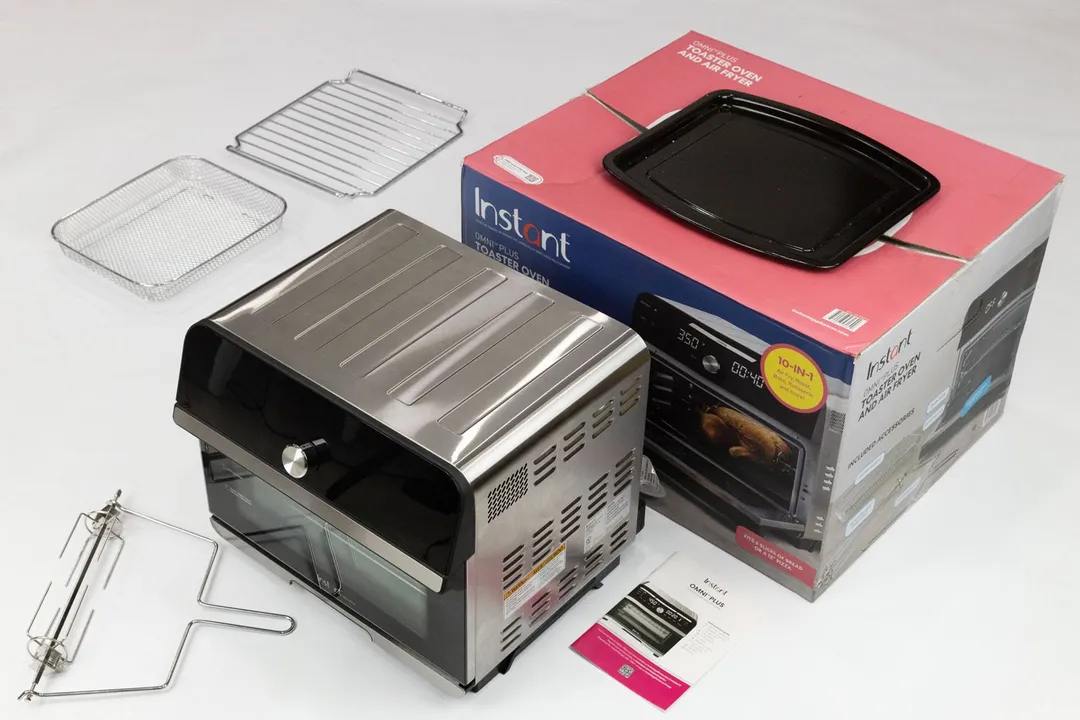 An oven rack, air fryer basket, rotisserie kit, lifter, the Instant Omni Plus 18L, user manual, box, and enamel baking pan.