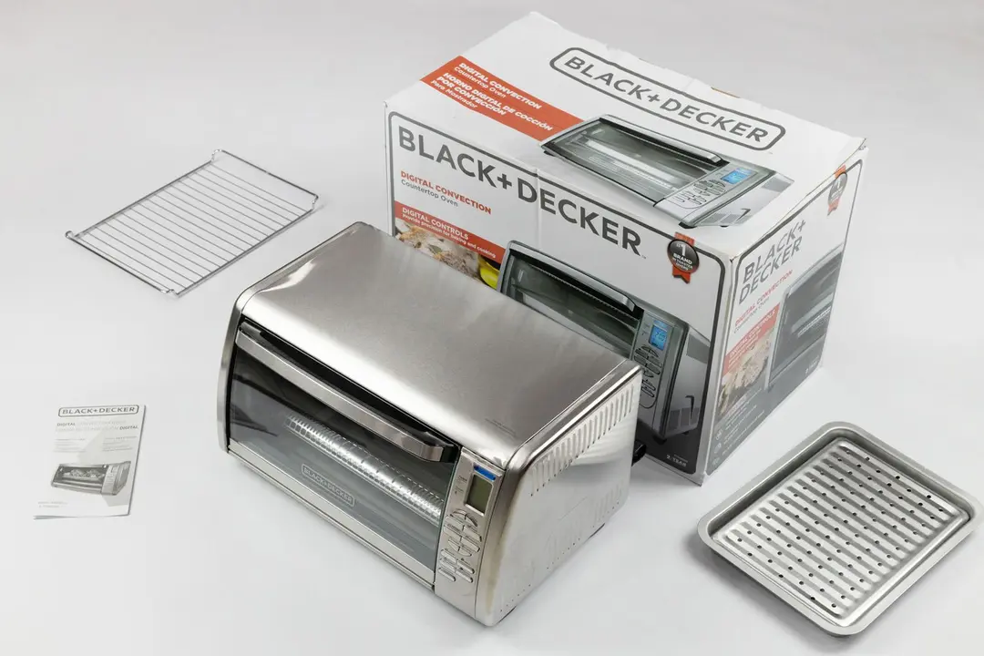 An oven rack, a user manual, the BLACK+DECKER CTO6335S Convection Toaster Oven, a box, a baking pan, and a broiling rack.
