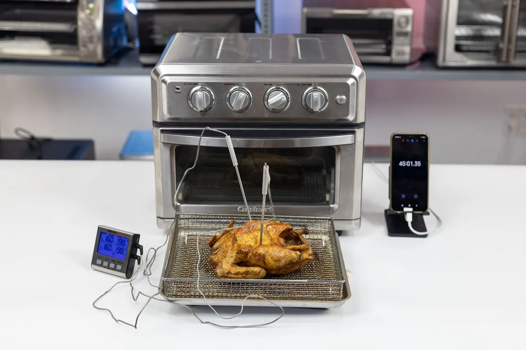 A tray of whole toaster oven roasted chicken. The thermometer has two probes inside the chicken and displays 198°F and 198°F.