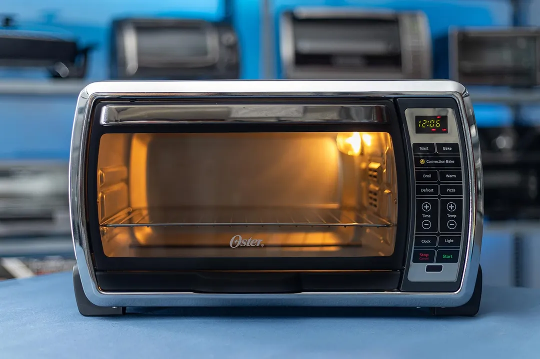The front of a closed stainless steel Oster TSSTTVMNDG-SHP-2 6-Slice Digital Convection Toaster Oven on a white background.