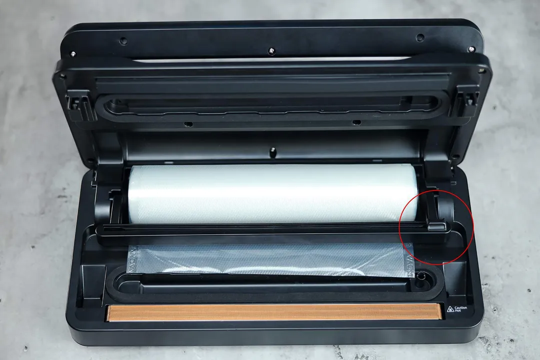 Inside the Anova Precision Pro is a large compartment that you can use to store a roll of plastic bag. There is a flip-down cutter for you to cut out any length of bag that you want.