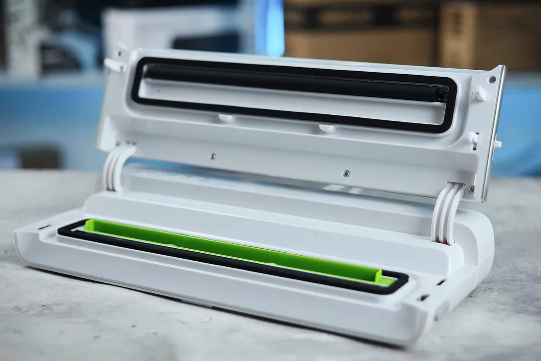 An interior shot of the FoodSaver VS-0160 vacuum sealer. A green protective bar covers the vacuum channel.