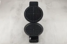 The Cuisinart WMR-CA with its lid opened, revealing the set of two black, non-stick-coated waffle plates.
