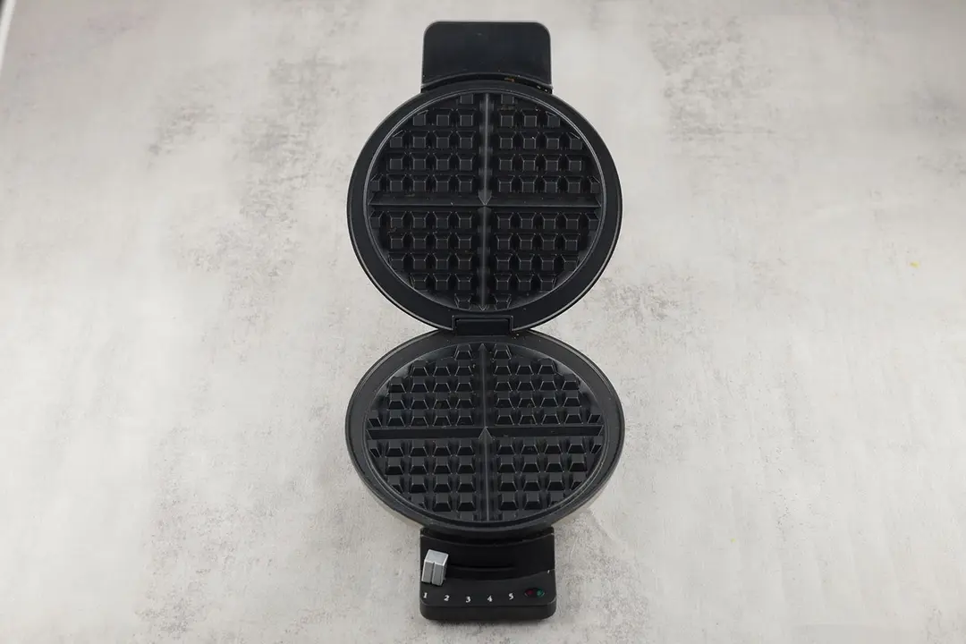 The Cuisinart WMR-CA with its lid opened, revealing the set of two black, non-stick-coated waffle plates.
